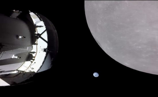 Šioje nuotraukoje, kurią šeštąją misijos „Artemis I“ dieną padarė kamera, esanti ant vieno iš „Orion“ saulės baterijų antgalio, matomas Mėnulis 130 km. atstumu nuo paviršiaus, o tolumoje – mūsų planeta Žemė. / NASA